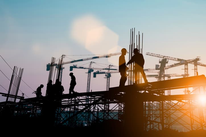 Silhouette of engineer and construction team working at site over blurred background sunset pastel for industry background with Light fair. Created from multiple reference images together.
