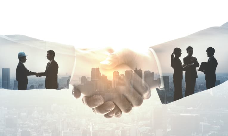 Handshake between suited people