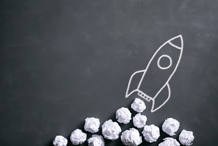 Space rocket on blackboard