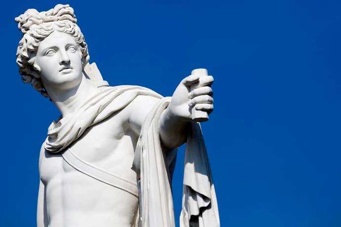 A statue of Greek god Apollo against a blue background