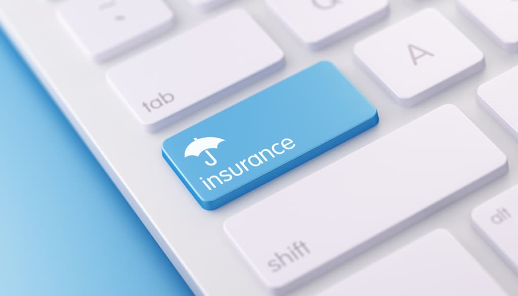 A white keyboard with a blue key that says 'insurance' on it