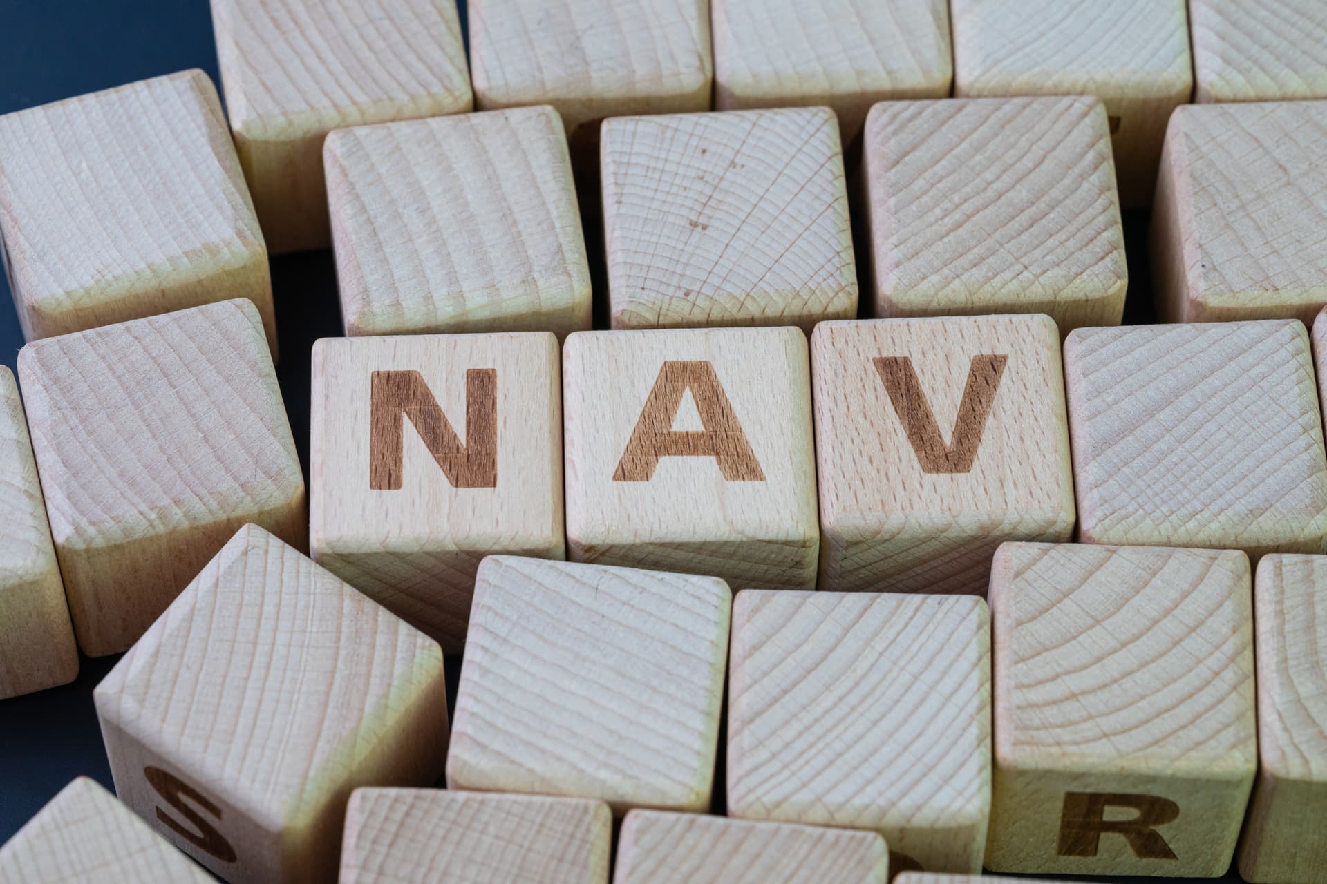 Blocks making up the acronym for net asset value, or NAV.