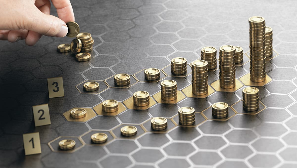 Piles of coins being placed strategically on a hexagon-tiled board
