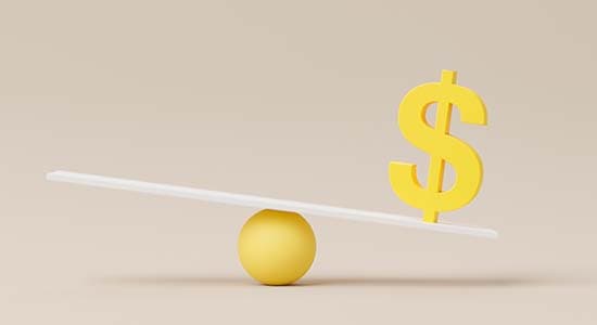 A yellow dollar sign balancing on a white see-saw