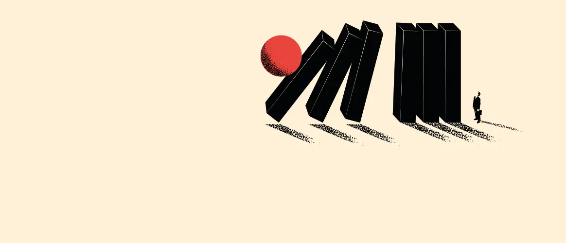 Image of dominos falling in line after a red ball hits the first one.