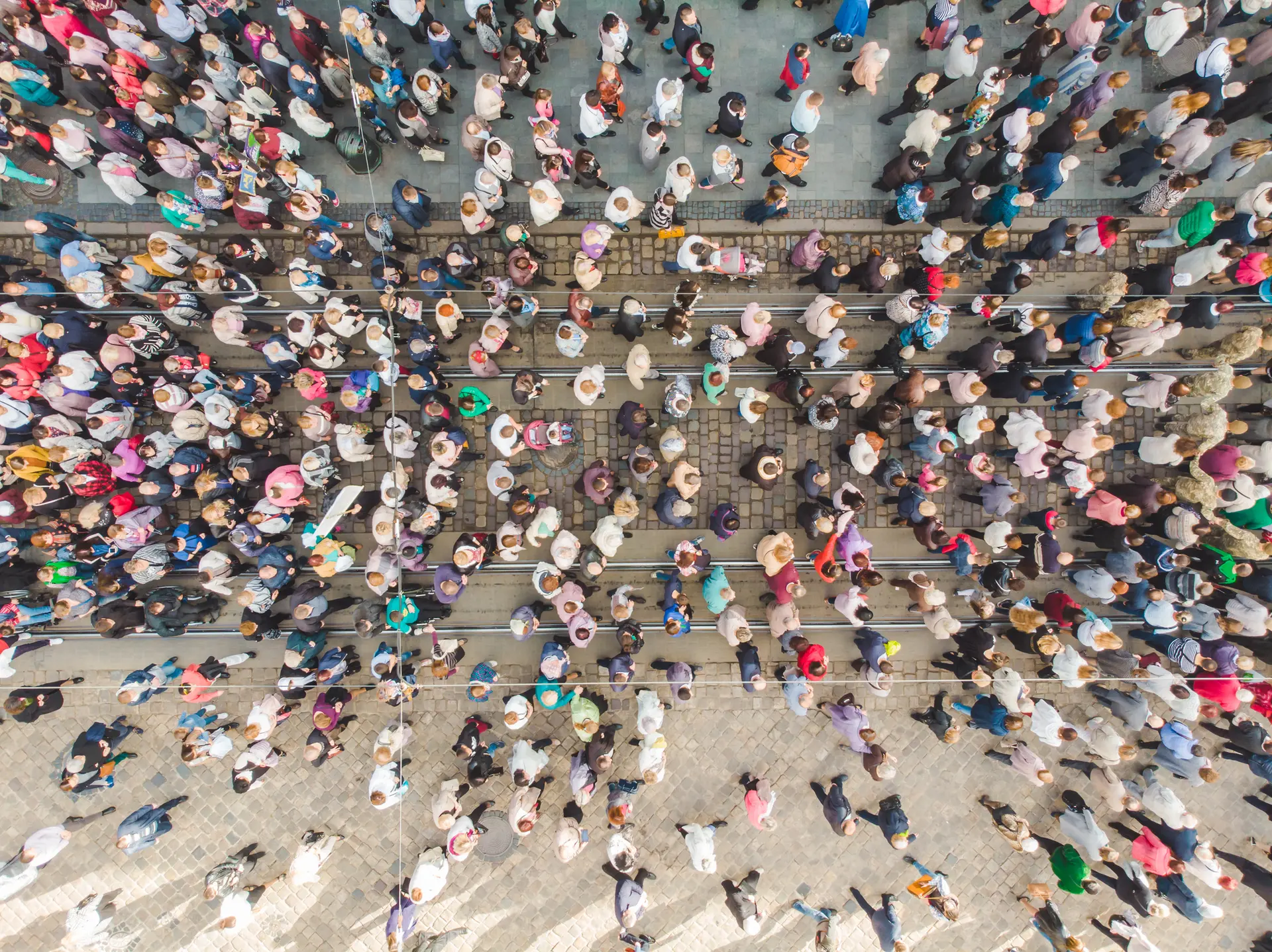 Birds eye view of crowds of people walking through a city