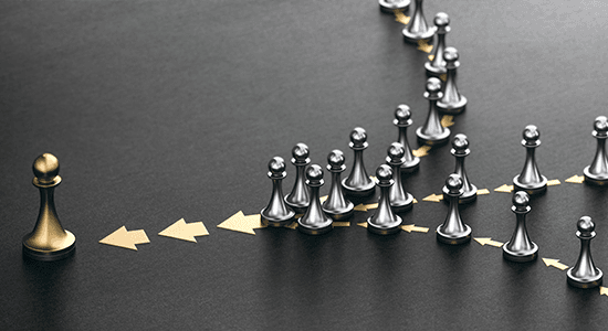 Silver pawns gather together to form a golden piece.