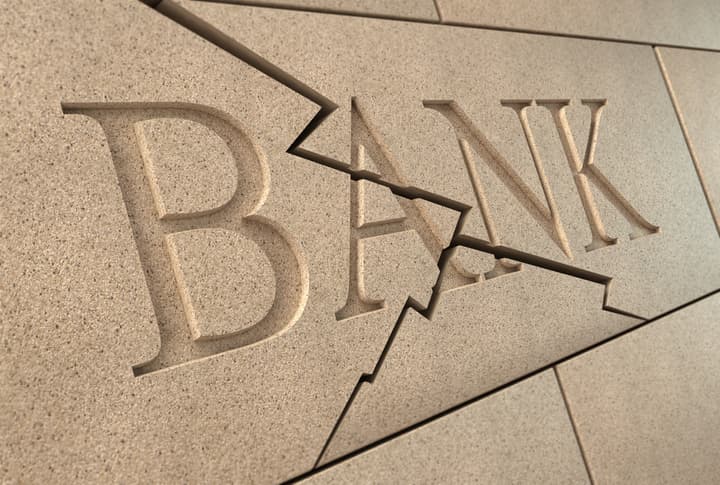 High quality 3d rendering of a sandstone 'BANK' sign breaking up with cracks