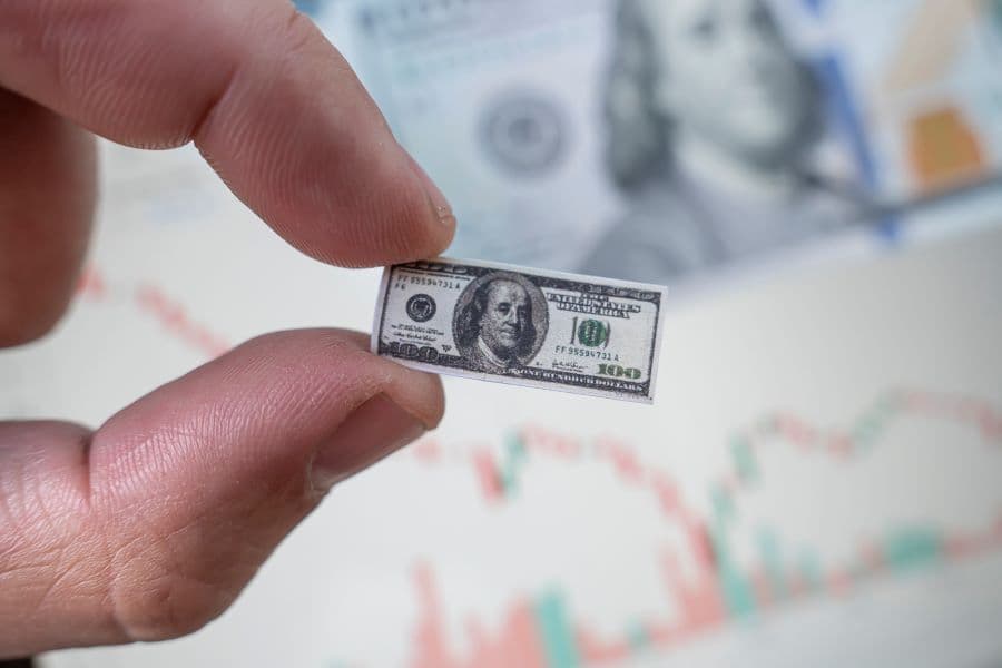 Photo concept of money shrinking in size.