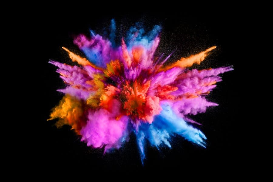 Photo of multicolored powders exploding.