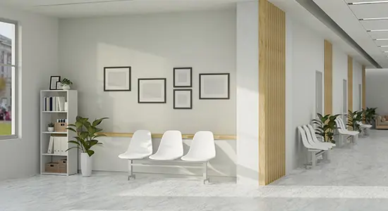Empty white chairs in a sand-colored medical office.