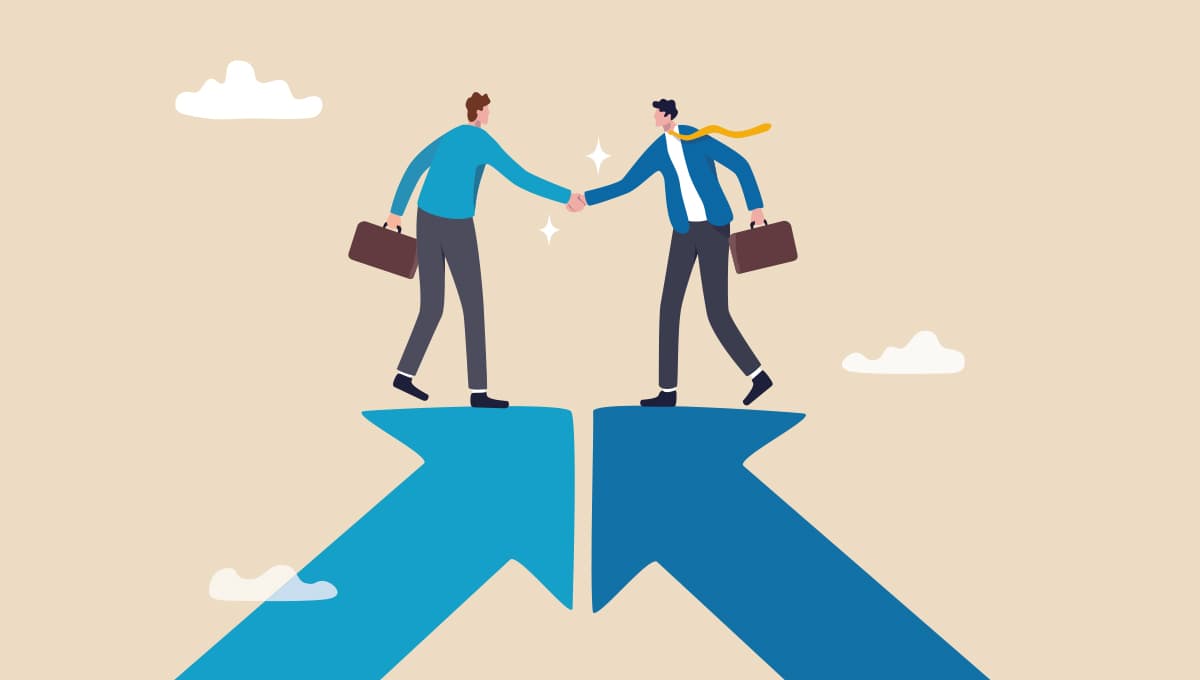 Two people stand on converging arrows and shake hands.