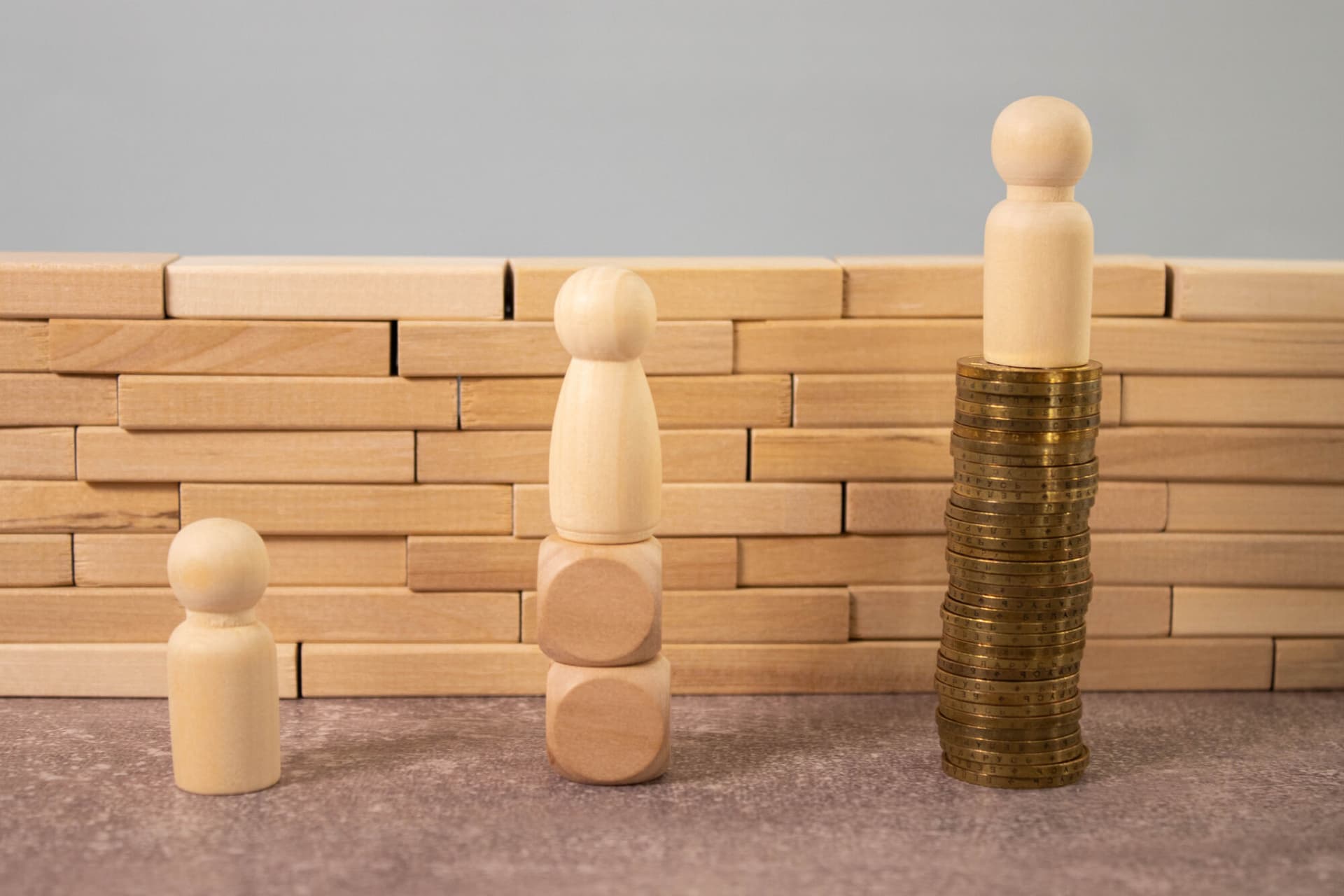 Miniature people standing on high and low. the gap between rich and poor according to an index of inequality.