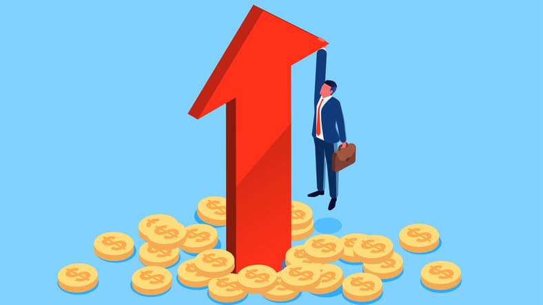 A giant red arrow lurches skyward as a man in a suit with a briefcase holds onwith one hand and dangles above the ground, which is strewn with dollar coins