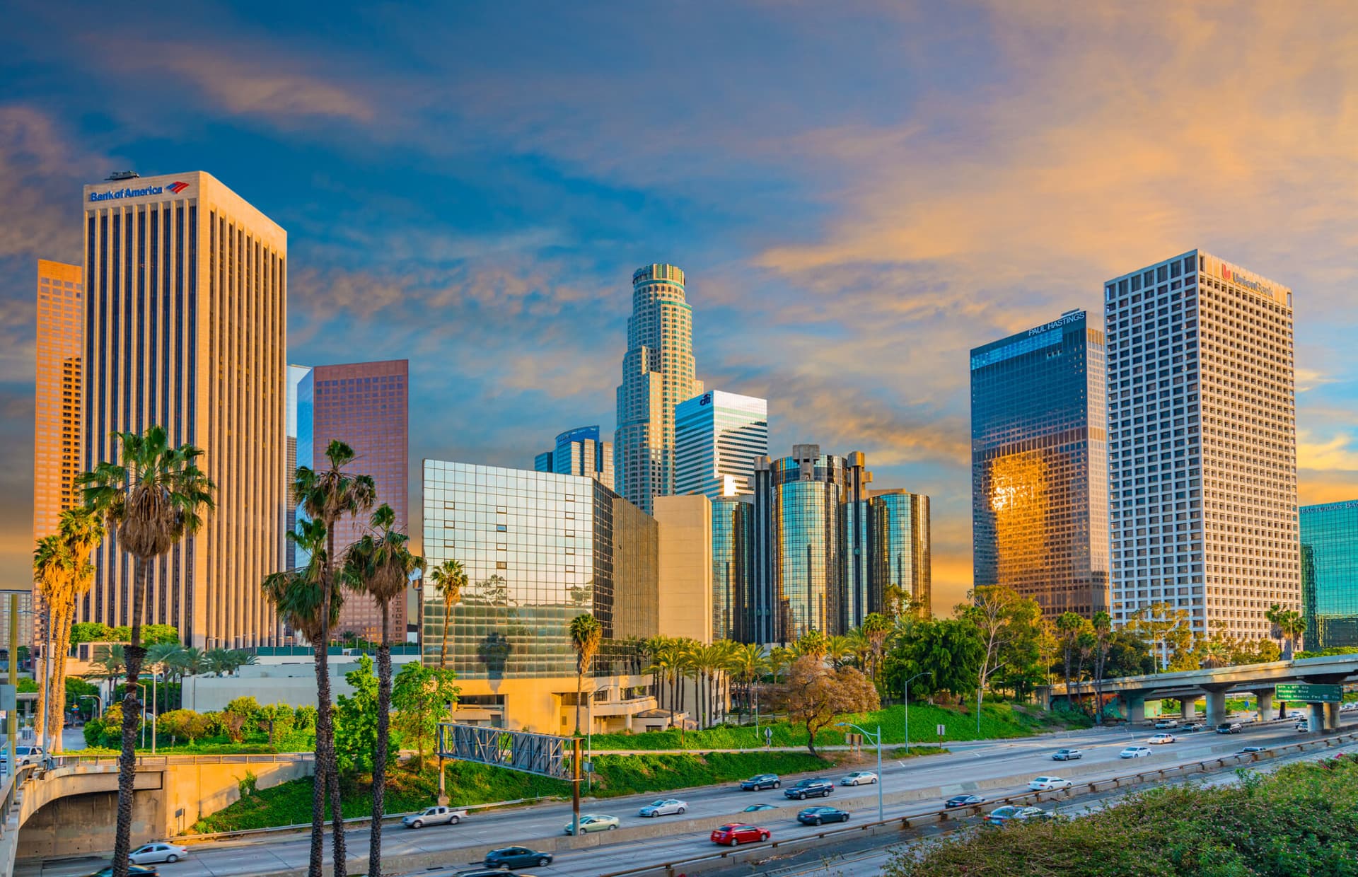 Dusk light with dramatic clouds in downtown Los Angeles and freeway, California.