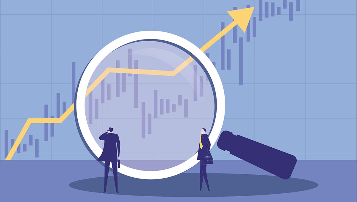 Two businessmen using a magnifying glass to observe market trends.