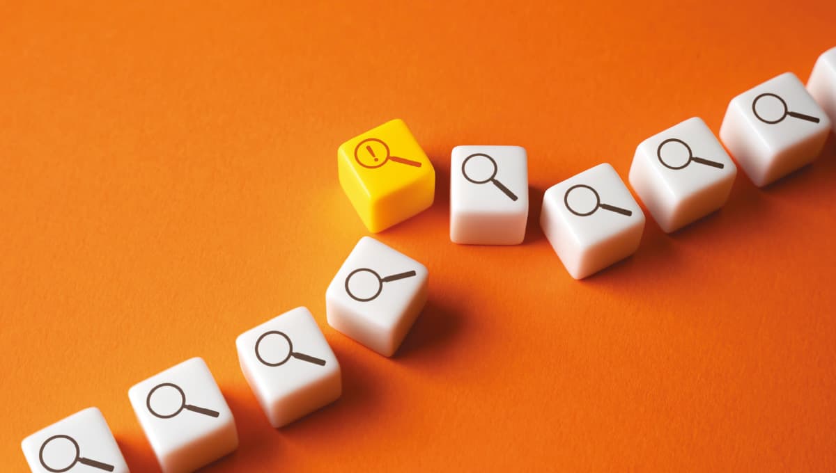 White cubes with a magnifying glass icon are lined up, with one yellow one bumped slightly out of line